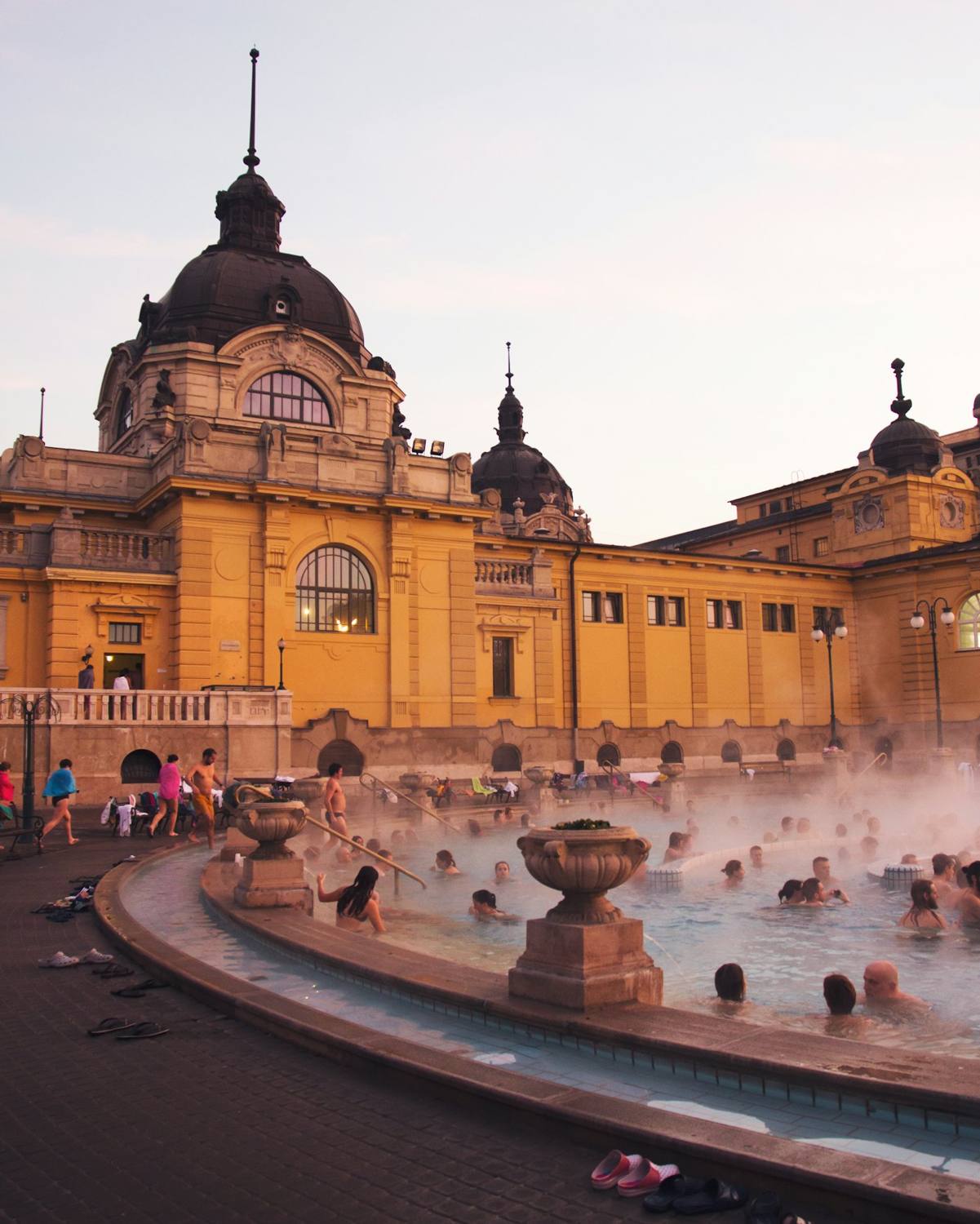 Steaming outdoor thermal pool at dusk — Széchenyi Baths, Budapest