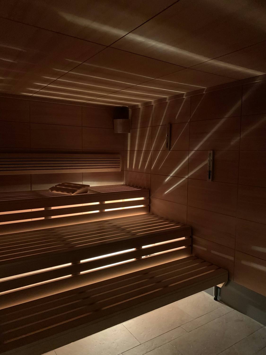 Empty wooden sauna with lit benches